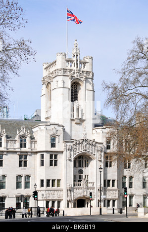 Union Jack Flag flying clear blue sunny day above tower of old Middlesex Guildhall building now UK Supreme court in Parliament Square London England Stock Photo