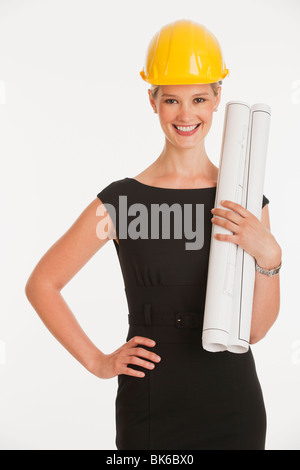 Female architect with blueprint isolated in white Stock Photo - Alamy