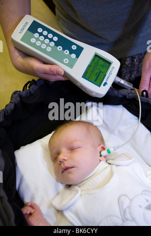 Newborn / new born baby undergoes a neonatal hearing screening test: Automated otoacoustic emissions test. Stock Photo