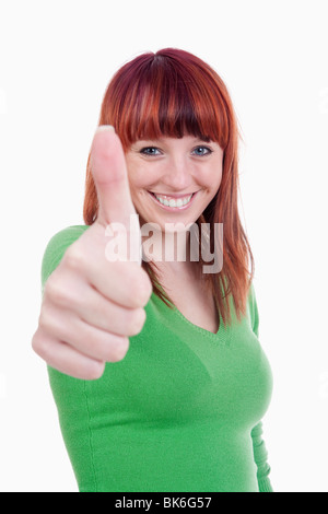 young cheerful woman showing thumbs up sign - isolated on white Stock Photo