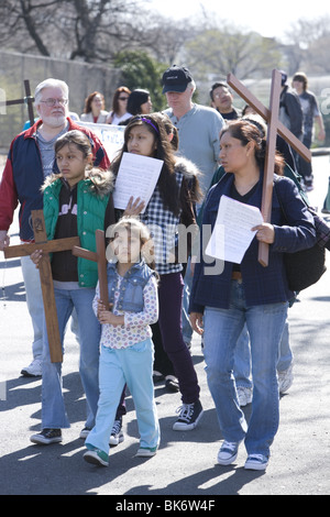 Roman Catholics of various ethnic groups participate on Good Friday in a procession of 'The Stations of the Cross' Stock Photo