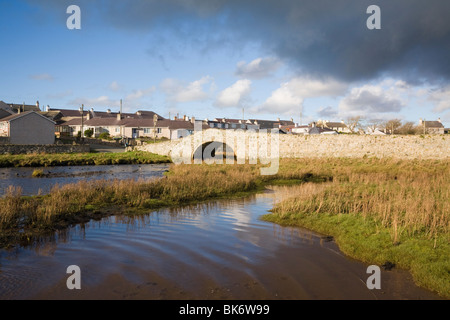 Salt marsh by tidal Afon Ffraw River estuary on coast with old bridge  (Hen Bont) to village of Aberffraw Isle of Anglesey North Wales UK Britain Stock Photo