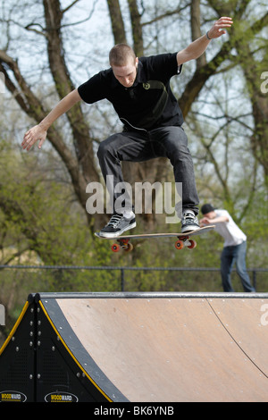 Skateboarder in mid-air over a ramp. Stock Photo