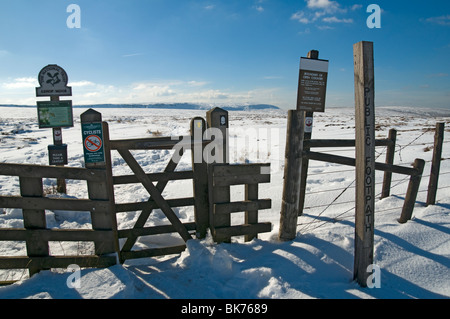 Signs and gate where the Pennine Way crosses the A57 Snake Pass road, Peak District, Derbyshire, England, UK Stock Photo