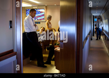 President Barack Obama confers with aides aboard Air Force One en route to Singapore, Nov. 14, 2009. Stock Photo