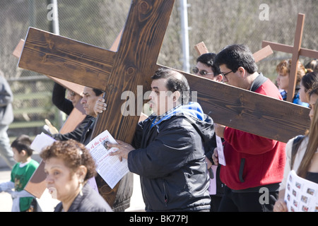 Roman Catholics of various ethnic groups participate on Good Friday in a procession of 'The Stations of the Cross' Stock Photo