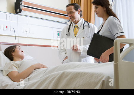 Young woman in hospital with doctor and nurse Stock Photo