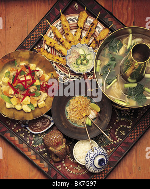 Fancy wood tray with tofu, rice, potstickers, and tempura pot. Stock Photo