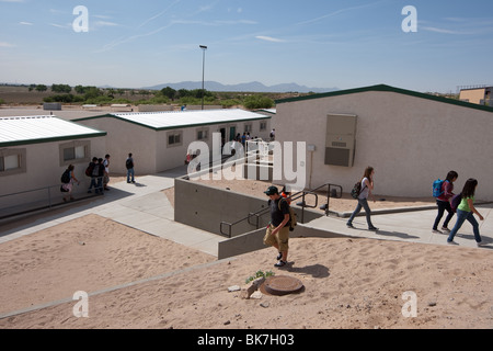 Exterior of students walking between portable buildings on campus of Mission Early College High School in El Paso, Texas. ©Bob Daemmrich Stock Photo