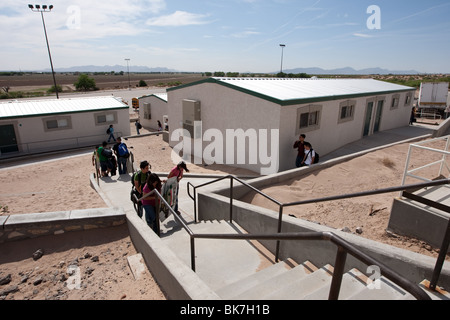 Exterior of students walking between portable buildings on campus of Mission Early College High School in El Paso, Texas. ©Bob Daemmrich Stock Photo