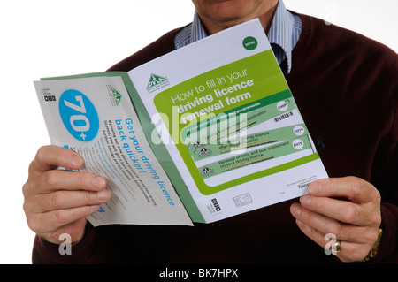 Driving Licence renewal form booklet & DLVA leaflet for drivers of 70 years plus. Man holding the documents Stock Photo
