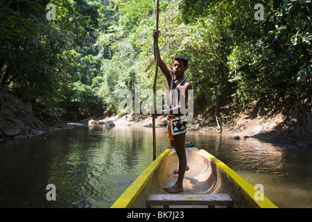 Embera Indian man in dugout canoe on Chagres River, Panama, Central America Stock Photo