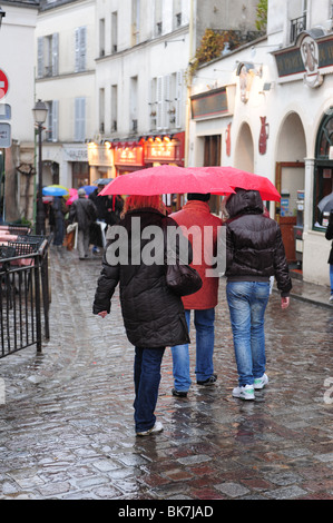 People in rainy weather, in rain gear, with umbrellas Stock Photo - Alamy