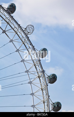 Looking up at Pods of the London Eye with a blue sky backdrop, one pod is missing Stock Photo