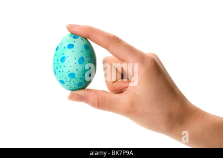 hand holding easter colored egg Stock Photo