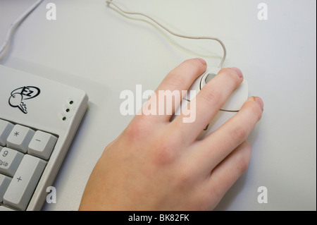 Childs hand operating a computer mouse. Stock Photo