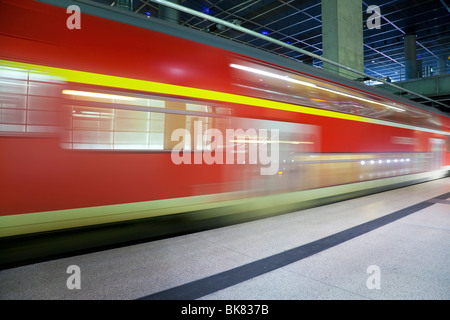 Europe, Germany, Berlin, modern train station - moving train pulling into the station Stock Photo