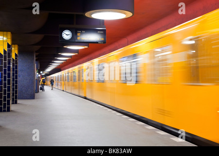 Europe, Germany, Berlin, modern subway station - moving train pulling into the station Stock Photo