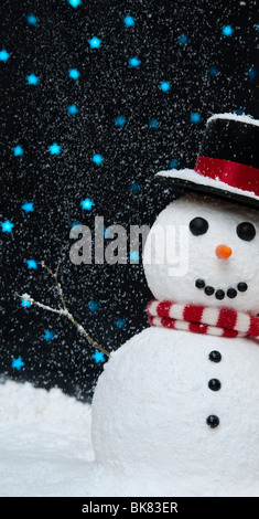 Snowman in the snow against starry night sky concept with copy space Stock Photo