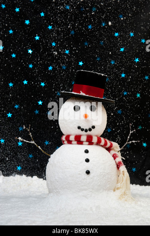 Snowman in the snow against starry night sky concept with copy space Stock Photo