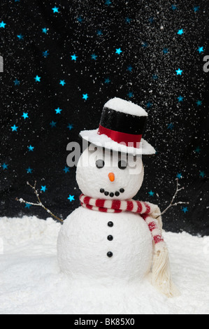 Snowman in the snow against starry night sky concept with copy space Stock Photo