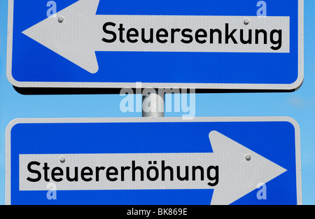 One-way street signs tax cut and tax increase Stock Photo