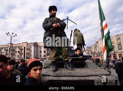 Chechen fighters stand on a captured Russia BMP outside the 'Presidential Palace' in central Grozny, Chechnya. Stock Photo