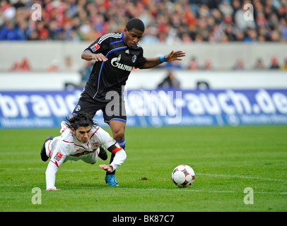 Jefferson Farfan, Schalke 04, standing, and Serdar Tasci, VfB Stuttgart, falling to the ground Stock Photo