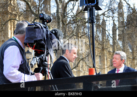 Sky News cameraman & TV presenter Dermot Murnaghan interviews Home Secretary Alan Johnson on podium outside Parliament College Green London England UK Stock Photo