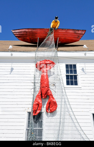 Lobstermen in boat with netting over side and lobster in netting on roof of Macs Seafood restaurant in Wellfleet, Cape Cod USA Stock Photo