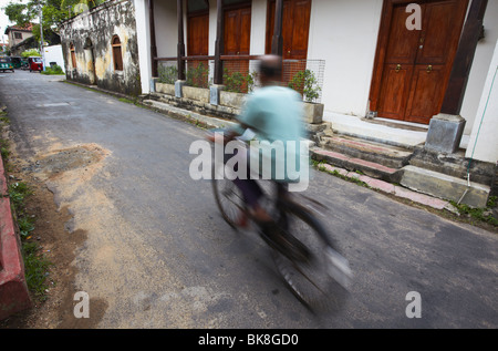 Man cycling in Old Town of Galle Fort, Galle, Sri Lanka Stock Photo