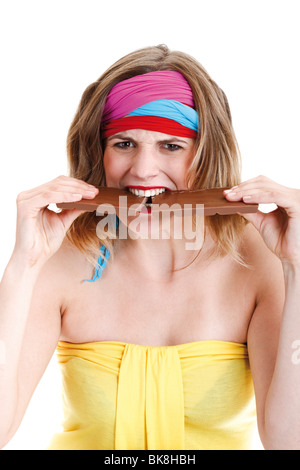 Young woman biting into a chocolate bar Stock Photo