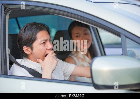 Young Man Yawning at Driver's Seat Stock Photo