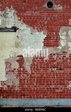 An old, red brick wall with cement patches. Suitable for backgrounds. Stock Photo