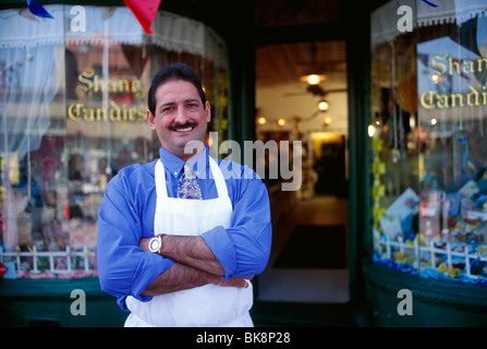 Proud owner and entrepreneur photographed in front of his candy store Stock Photo