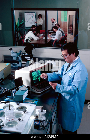 Male Asian scientist works in a pharmaceutical company research and development laboratory. Managers meet in a conference room. Stock Photo