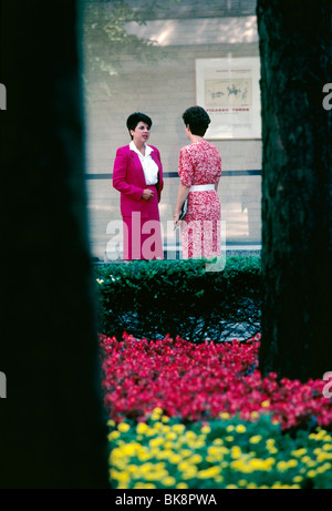 Two business woman meeting in the courtyard of a pharmaceutical company. Stock Photo