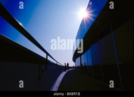 Two business women standing outside on a balcony of a corporate office building in southern California, USA Stock Photo