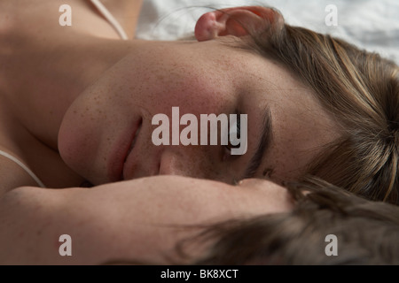 Detail of young couple lying on bed Stock Photo