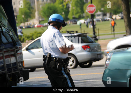 police officer gives a car a parking ticket in Washington, DC Stock Photo