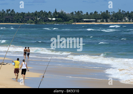 Two couples walking on Nukuolii Beach Kauai HI Stock Photo
