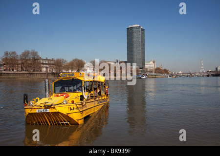 Scene along the River Thames as a Duwk amphibious vehicle drives out of the river onto dry land. The Duck Tours company. London Stock Photo