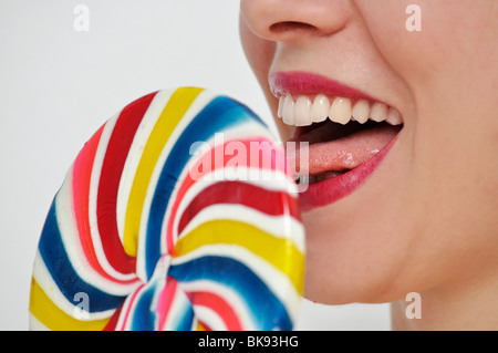 Young woman eating lollipop Stock Photo