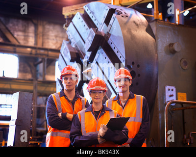 Steel Engineers In Front Of Lathe