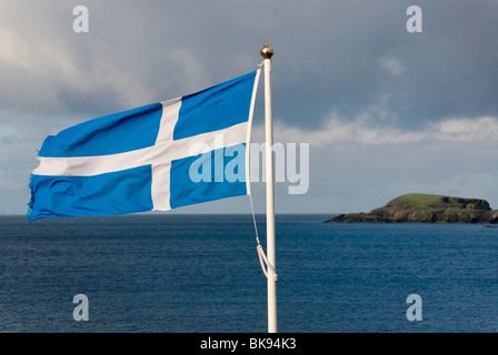 Flag of Scotland, in the back an island, Scotland, United Kingdom, Europe Stock Photo