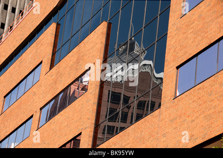Image showcasing Modern brick and glass facade of the office building. A contrasting ...