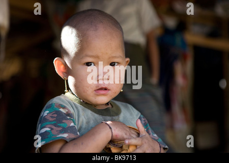 An ethnic Burmese refugee baby at the Mae La Refugee Camp, in Northern Thailand. Stock Photo