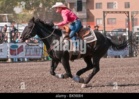 Cowgirl riding fast during barrel racing, Cochrane Rodeo, Cochrane, Alberta, Canada Stock Photo