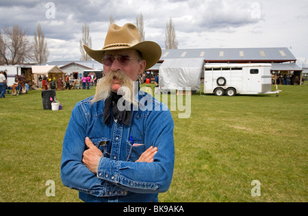A cowboy wearing a long mustache at a county fair in Madras, Oregon Stock Photo