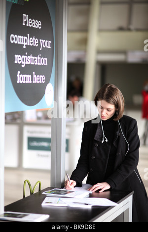 A woman fills in a registration form Stock Photo